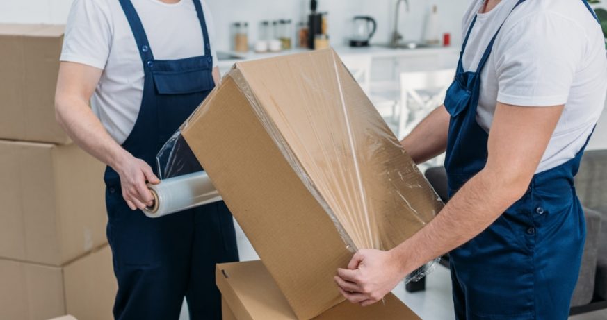 Movers Wrapping Boxes in Pallet Wrap — The Packing & Moving Company in Tanah Merah, QLD