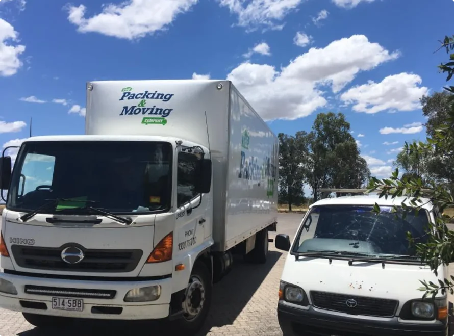 Removals Truck And White Van Parked — The Packing & Moving Company in Tanah Merah, QLD
